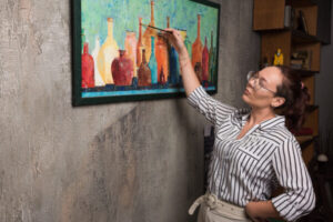 woman artist paints picture canvas with brush marble background 600x400 1